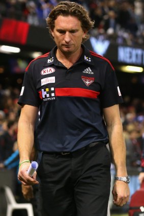 A downcast James Hird leaves the field after his team lost to North Melbourne on Friday night.