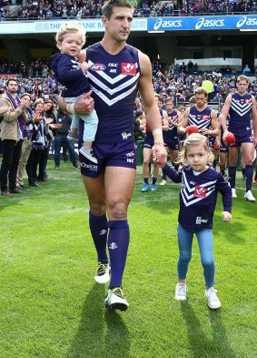 Matthew Pavlich makes his way onto the ground with children Jack and Harper.