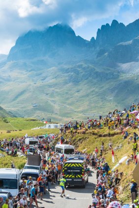 Specific vehicles which end each stage during Tour de France, driving on the road to Col du Glandon in Alps.