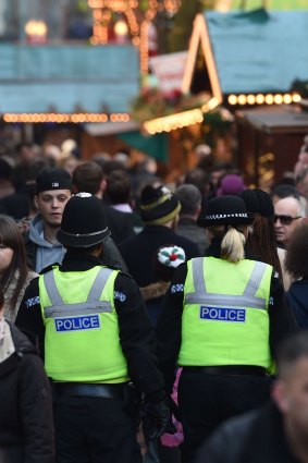 British police patrol Birmingham Christmas market.