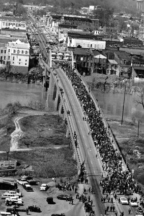 Civil rights marchers cross the Alabama river on the Edmund Pettus Bridge at Selma March 21, 1965, with Dr. Martin Luther King Jr. at the lead at the start of a five day, 50-mile march to the State Capitol of Montgomery for voter registration rights for blacks.