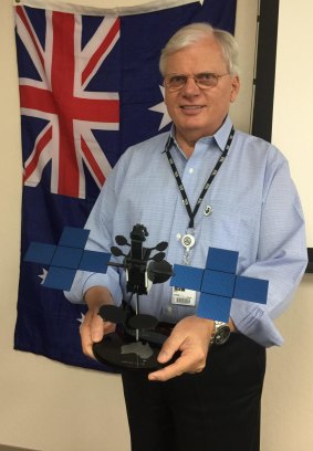 Space Systems Loral president John Celli, without a tie, holds a model of NBN's Sky Must II satellite.