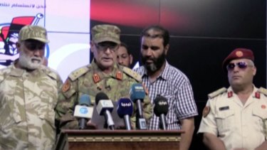 Brigadier-General Mohammed al-Ghasri, second left, spokesman for Al Bonyan Almrsos military operation fighting in Sirte, speaks at a news conference in Misrata, Libya. 