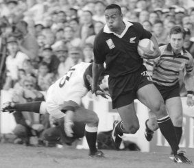 On the rampage: New Zealand winger Jonah Lomu moves past England's Will Carling on his way to score the opening try in Rugby World Cup semi-final clash at Newlands, Cape Town, on June 18, 1995. 
