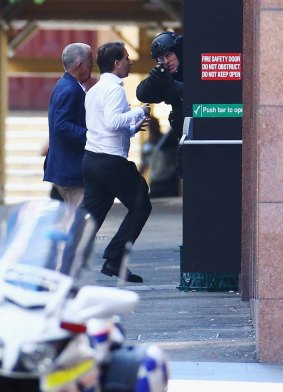 John O'Brien and Stefan Balafoutis flee from the Lindt cafe during the siege.