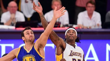 Tip-off: Warriors centre Andrew Bogut and Lakers big man Jordan Hill compete for the ball..
