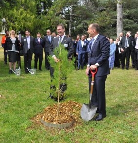 Prime Minister Tony Abbott plants a sapling with Ian Irving, chief executive for Australia, Northrop Grumman, at the launch of the Soldier On, Hand Up program.