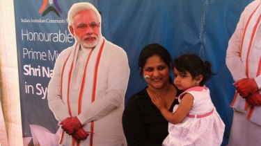 Members of the Indian community pose with a cutout of Narendra Modi at Homebush on Monday.