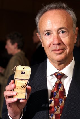 Andy Grove displays in 1998 the original "passport" identification tag supplied to him in 1957 on his arrival in the US.