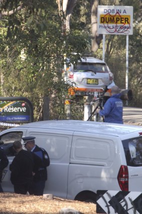 Police at Lambeth Reserve, off Henry Lawson Drive, where the body was found.