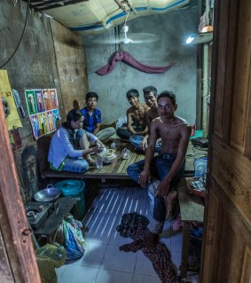 A family of five live in this tiny room made of scrap timber and cardboard  near a Phnom Penh garment factory.