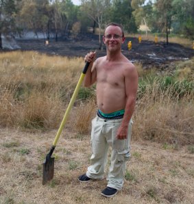 Resident Nick Hart ready to fight the fires as Emergency services attend a small grass fire in Umbagong District Park in Latham. 