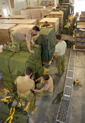Personnel from 176 Air Dispatch Squadron prepare airdrop bundles of humanitarian aid bound for Iraq. 