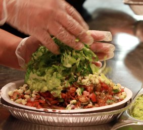 The final touches are added to a Burrito Bowl at a Chipotle restaurant.