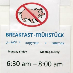 A sign gives details for breakfast at an emergency accomodation shelter for asylum applicants in Berlin. 