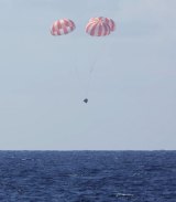 The Dragon capsule uses parachutes to land in the Pacific Ocean after returning from the International Space Station earlier this month.