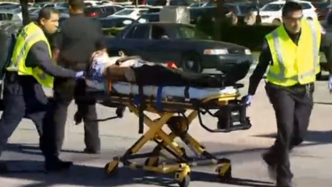 A victim of the shooting is taken away by paramedics.