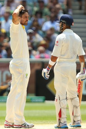 Mitchell Johnson and Virat Kohli exchange pleasantries on day three of the Boxing Day Test.
