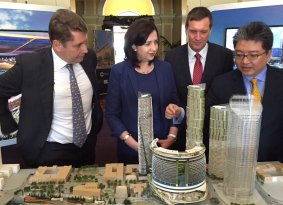 Star Entertainment CEO Matt Bekier shows Queensland Premier Annastacia Palaszczuk, State Development Minister Anthony Lynham and Far Eastern Consortium director Chris Hoong features of the Queens Wharf Brisbane model.