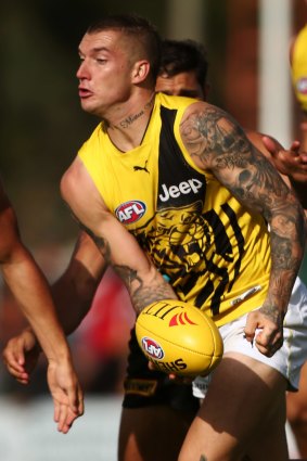 In the thick of it: Dustin Martin looks to handball.