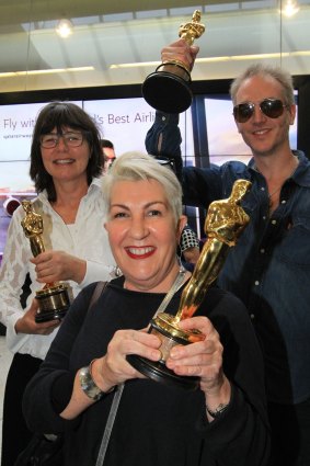 Happy trio ... Margaret Sixel, left, Lesley Vanderwalt  and Damian Martin with their Oscars at the airport. 
