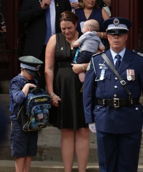 Senior Constable Margaret King and her children Aiden and Patrick, wearing his father's police hat.