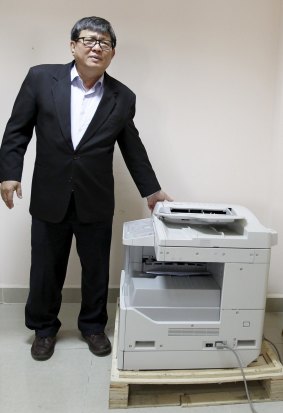 Son Chhay, a parliamentarian with the Cambodia National Rescue Party (CNRP), stands next to a copy machine - iSon Chhay has found that a copying machine has been corruptly declared at US$35,000. 