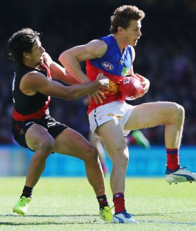 Mark Baguley of the Bombers tackles Ryan Lester.