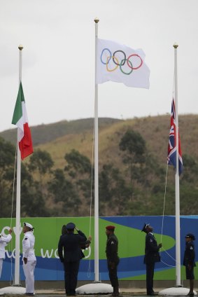 The Olympic flag is raised at the medal ceremony.