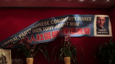 A poster falls at a Chinese Liberal party fundraising dinner in Sydney in 2010.