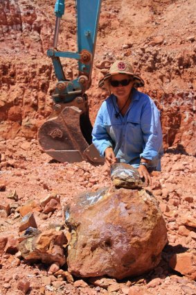 Sue Cooper with a boulder that has been split to reveal "colour". There's no guarantee, even when boulders are next to each other.
