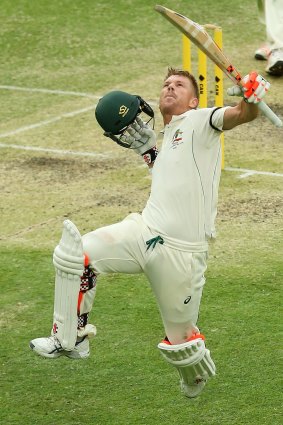 Australia's David Warner celebrates reaching his second century of the first Test against New Zealand at the Gabba, on day three.