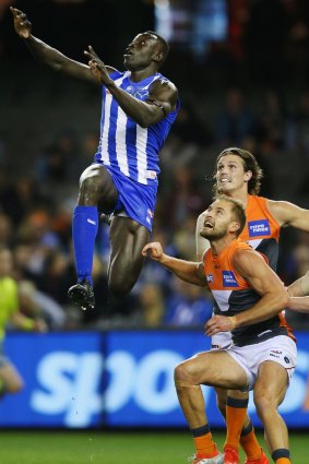 Kangaroo Majak Daw flies for the footy during North Melbourne's loss to GWS.