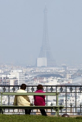The Eiffel Tower disappears behind a blanket of small-particle haze caused by car fumes.