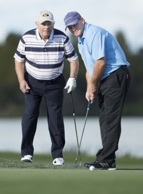 Jack Nicklaus talks to his son Gary during the first round of the recent Father/Son Challenge golf tournament in Orlando.