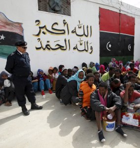 Illegal migrants sit at Abu Saleem detention centre.