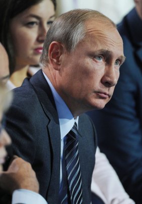 Russian President Vladimir Putin listens to a question during a meeting with supporters in Moscow.