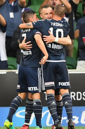 Berisha is congratulated after scoring from the spot, before he was shown the red card.