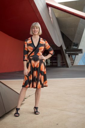 Yumi Morrissey from Zilpah Tart wearing a dress from her new collection, with a print featuring the National Museum of Australia.