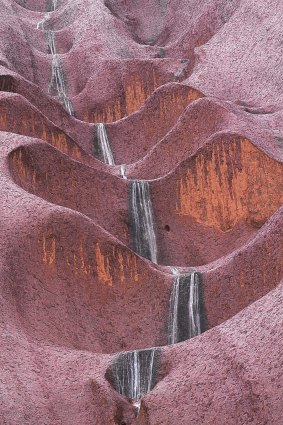 When it rains, water tumbles down the side of Uluru in spectacular waterfalls.