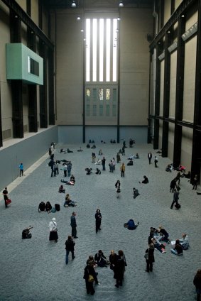 Visitors explore Ai Weiwei's installation Sunflower Seeds in the Tate Modern.