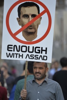 A demonstrators holds a placard depicting Syrian President Bashar Assad, during a protest against Russian military operations in Syria, in Istanbul, Turkey, on Saturday.