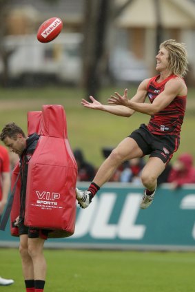 Up, up: Heppell has a spring in his step at Essendon training.
