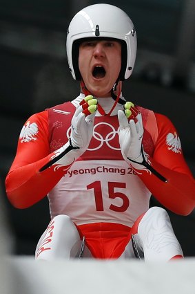 No visor: Mateusz Sochowicz of Poland brakes in the finish area during final heats of the men's luge competition.