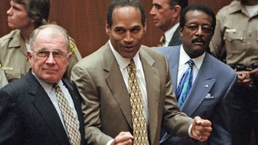 Simpson pumps his fists in victory upon being found not guilty in October 1995. He is flanked by lawyers F Lee Bailey and Johnny Cochrane.