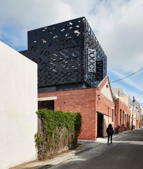 DKO Architecture retained the lower brick heritage building and added a lightweight laser-cut screen above.