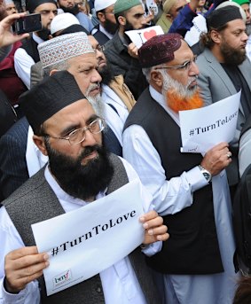 Members of the British Muslim Forum with religious leaders from Christian and Jewish faiths pay their respects at St Ann's square in Manchester on Sunday.