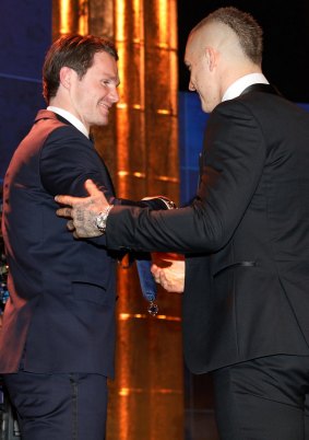 Patrick Dangerfield presents Dustin Martin with his Brownlow Medal.