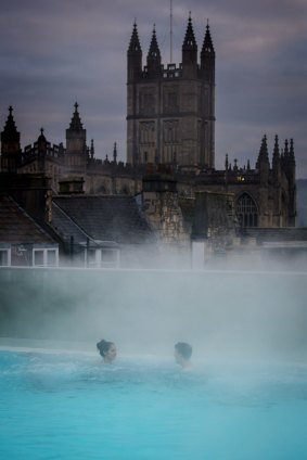 Visitors enjoy the naturally warmed spa water in the rooftop pool, Bath England. 