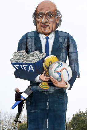 Artist Frank Shepherd puts the final touches to Edenbridge Bonfire Society effigy of FIFA president Sepp Blater